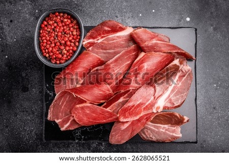 Sliced prsut prshut, Balkan cured pork meat ham. black background. top view.