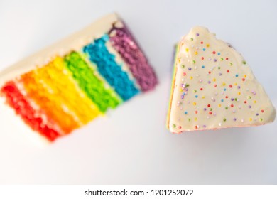 Sliced rainbow cake in a withe surface