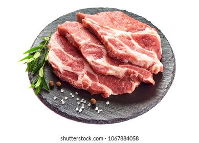 Sliced raw pork meat on stone plate, isolated on white background.