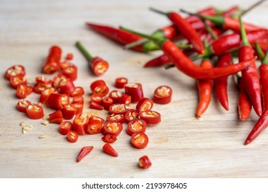 Sliced Red Chilli And Chili Seeds On A Wooden Cutting Board