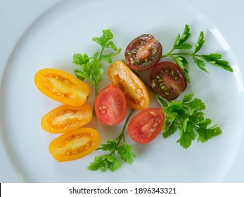 Sliced Red, Yellow, Orange Grape Tomatoes with Parsley Leaves on White Backgrounds - Powered by Shutterstock