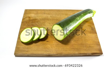 Sliced regular Zucchini, courgette on a wooden Cutting board - isolated