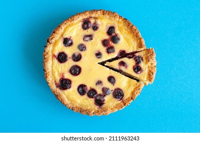 Sliced Ricotta Cheese Pie With Cherries On A Blue Background. Top View. Hearty Baking.