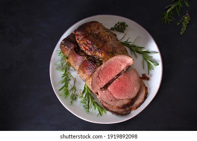 Sliced Roast Beef With Herbs On Plate. Overhead Horizontal Photo