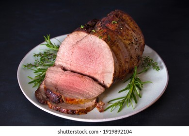 Sliced Roast Beef With Herbs On Plate. Horizontal Photo