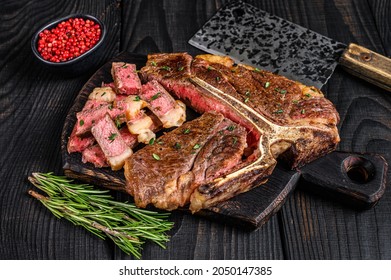 Sliced And Roast T-bone Or Porterhouse Beef Meat Steak For Steakhouse Menu. Black Wooden Background. Top View