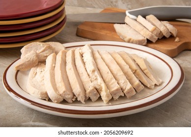 Sliced Roasted Chicken Breast On A Platter By A Cutting Board