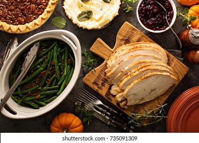 Sliced Roasted Tukey Breast For Thanksgiving Or Christmas Dinner With Side Dishes Overhead Shot