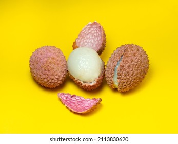 Sliced ​​lychee. Round pimply fruits. Chinese plum. Fruit peel. Peeling the lychee. Pieces of juicy fruit on a bright background. Plum pulp.