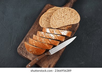 Sliced rye bread on cutting board. Whole grain rye bread  - Powered by Shutterstock