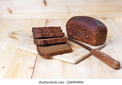Sliced rye bread on cutting board - Shutterstock ID 236994904