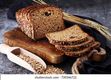 Sliced rye bread on cutting board. Whole grain rye bread with seeds - Shutterstock ID 739346722