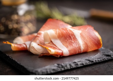 Sliced schwarzwald ham. Dried prosciutto ham on a cutting board.