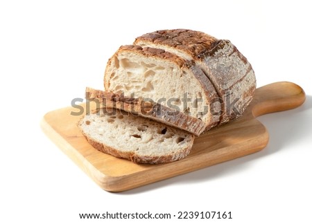 Sliced Sourdough Bread on wood board isolated on white background, homemade bakery concept