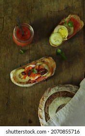 Sliced Sourdough Bread With Tomato Paste, Egg And Cucumber On Top