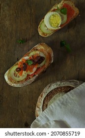 Sliced Sourdough Bread With Tomato Paste, Egg And Cucumber On Top