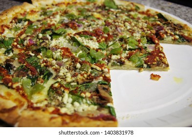 Sliced Spinach Cottage Cheese Pizza With Red Sauce Swirl Cut In Geometric Shapes Facing Downward