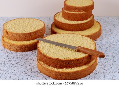 Sliced Sponge Cake With Knife On Table For Making Layer Wedding Cake.