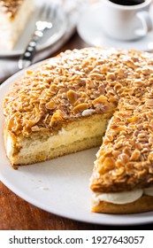 Sliced sweet almond cake. Pie with cream and almonds.