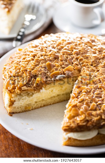 Sliced\
sweet almond cake. Pie with cream and\
almonds.