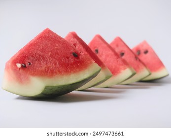 Sliced ​​watermelon in triangular shape on white background