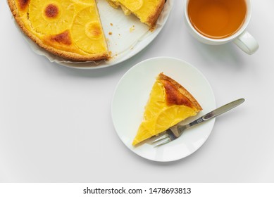 Sliced Upside Down Pineapple Cake With Cup Of Tea On White Table. Summer Tropical Dessert. Top View. Copy Space