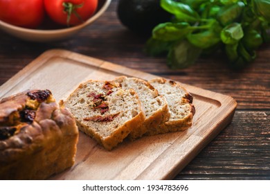 Sliced wheat rye sourdough bread stuffed with sun-dried tomatoes and rosemary.