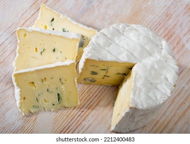 Sliced Wheel Of Natural Blue Cheese With Creamy Structure On Wooden Background