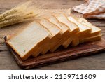 Sliced white bread on wooden board