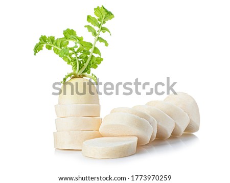 sliced white radish with green leaves isolated on white background