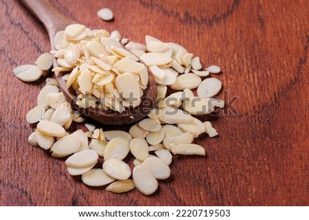 Sliced ​​almonds in wooden spoon and wooden background.Copy space. Foto stock © 