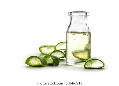 Slices of a aloe vera leaf and a bottle with transparent gel for medicinal purposes, skin treatment and cosmetics, isolated on a white background, close up shot, selective focus,narrow depth of field