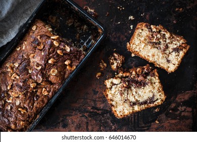 Slices Of Banana Bread With Hazelnut And Chocolate, Loaf Cake From Above. Dark Food Photography.