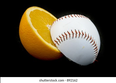 Slices Of Baseball Ball And Orange On Black Background