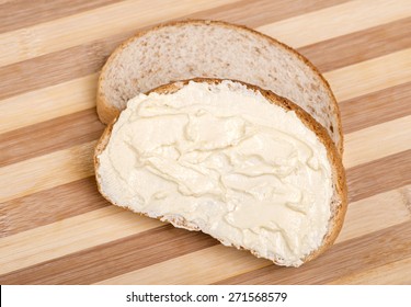 Slices of bread spread with butter - Powered by Shutterstock