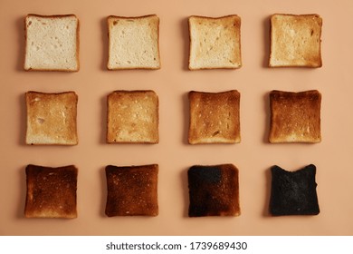 Slices Of Bread Of Various Degree Of Toastiness Arranged In Rows Against Beige Background. Toast Or Snack For Eating. Stages Of Toasting. Healthy Eating, Munchies And Dieting Concept. Studio Photo