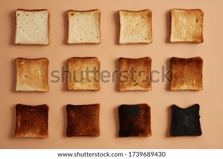 Image, Stock Photo Toasted toast bread in toaster on pink background