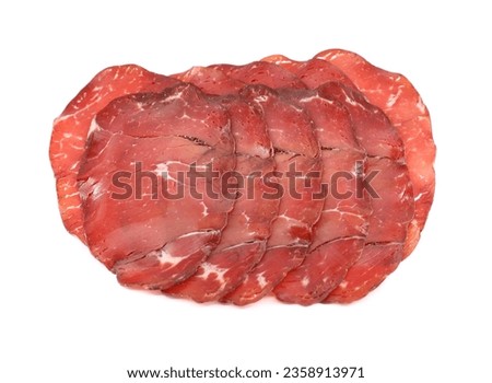 Slices of Bresaola della Valtellina, bottom sirloin cut, on white background. It is a traditional air dried salted beef cold meat from Lombardy, in Italy.