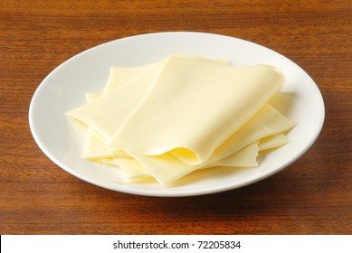 Slices Of Cheese On White Plate