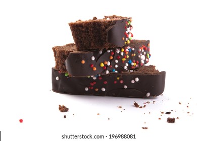 Slices Of Chocolate Cake On Each Other Isolated On White Background With Lots Of Crumbs