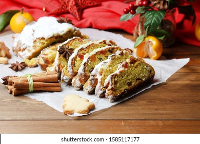 Slices Of Christmas Stolen Powdered Sugar With Spices And Cookies On Wooden Table. Side View.