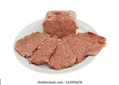 Slices of corned beef on a plate isolated against white