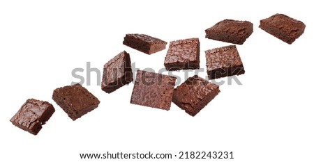 Slices of delicious chocolate brownie flying on white background. Banner design