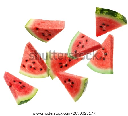 Slices of delicious ripe watermelon falling on white background 