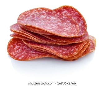 Slices of dry salame. Small heap of sausage slices. Cutted salami on white bg. Isolated on white background with shadow reflection. With clipping (vector) path. Italian sausage on reflective underlay.