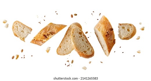 Slices of fresh baked wheat baguette with sunflower, sesame seeds and crumbs flying isolated on white background. Healthy pastry food - Powered by Shutterstock