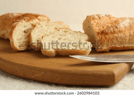 Slices of fresh bread on light textured table, closeup
