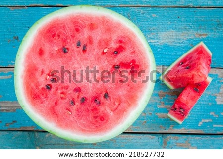 slices of fresh juicy organic watermelon on a wooden background