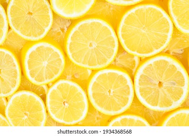 A slices of fresh juicy yellow lemons.  Texture background, pattern.
