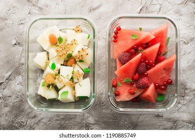 Slices Of Fresh Melon And Watermelon With Fresh Garden Berries In Trendy Glass Containers Of Rectangular Shape On The Background. Top View. Healthy Snack In Road Fitness Food